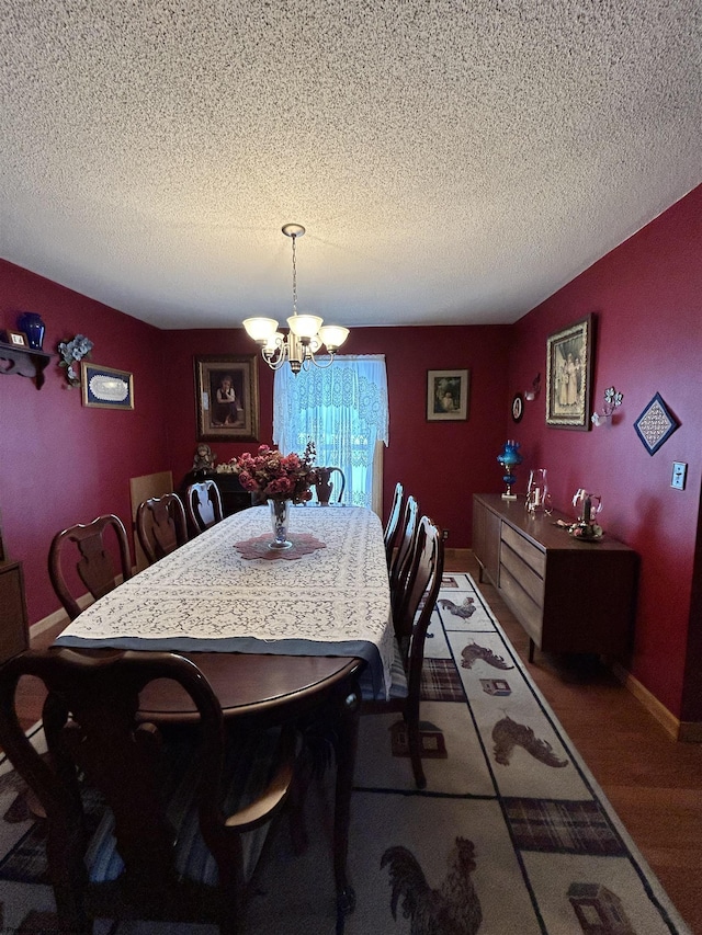 dining room with a notable chandelier and a textured ceiling