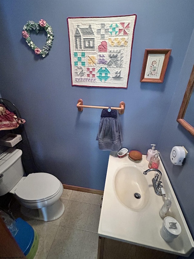 bathroom with vanity, tile patterned floors, and toilet