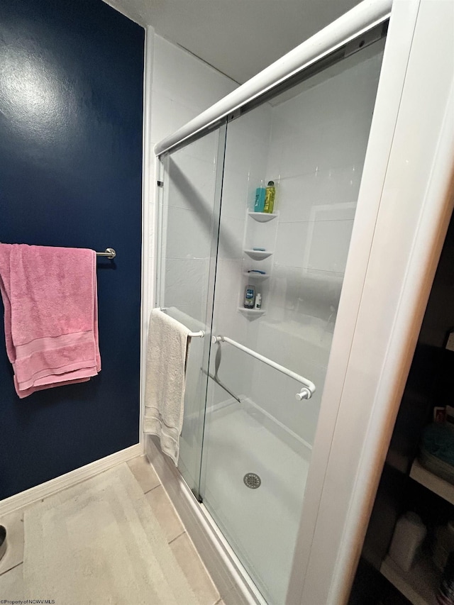 bathroom featuring hardwood / wood-style floors and a shower with door