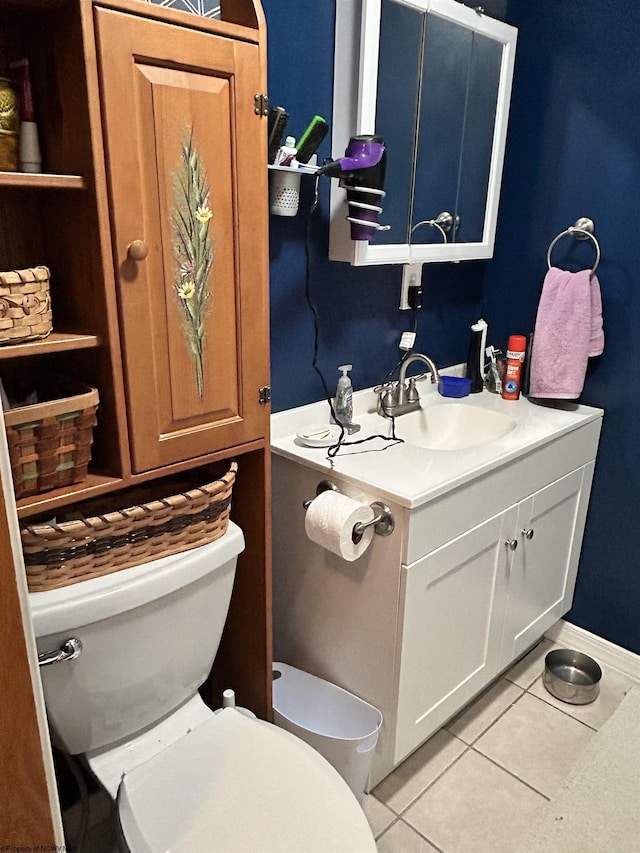 bathroom with tile patterned flooring, vanity, and toilet