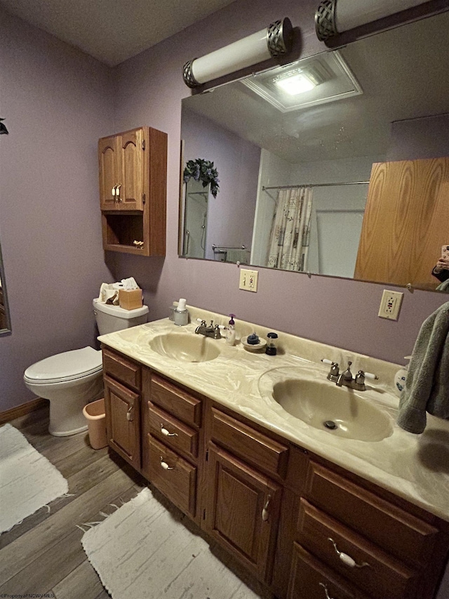 bathroom with vanity, hardwood / wood-style floors, a shower with shower curtain, and toilet