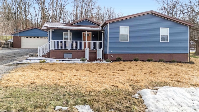 view of front of house with an outbuilding, a garage, and covered porch