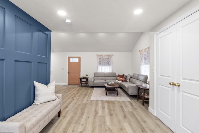 living room with lofted ceiling and light hardwood / wood-style floors