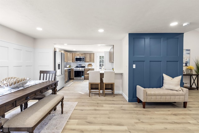 dining space featuring light wood-type flooring