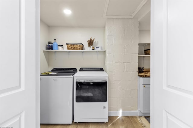 laundry area featuring light wood-type flooring and washer and clothes dryer