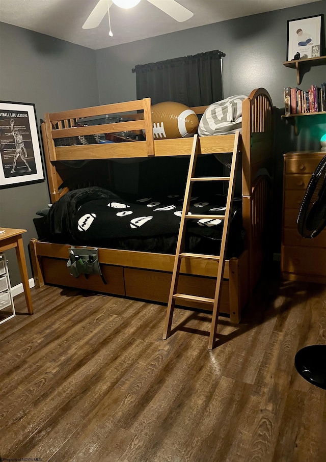 bedroom with washer / dryer, dark hardwood / wood-style floors, and ceiling fan