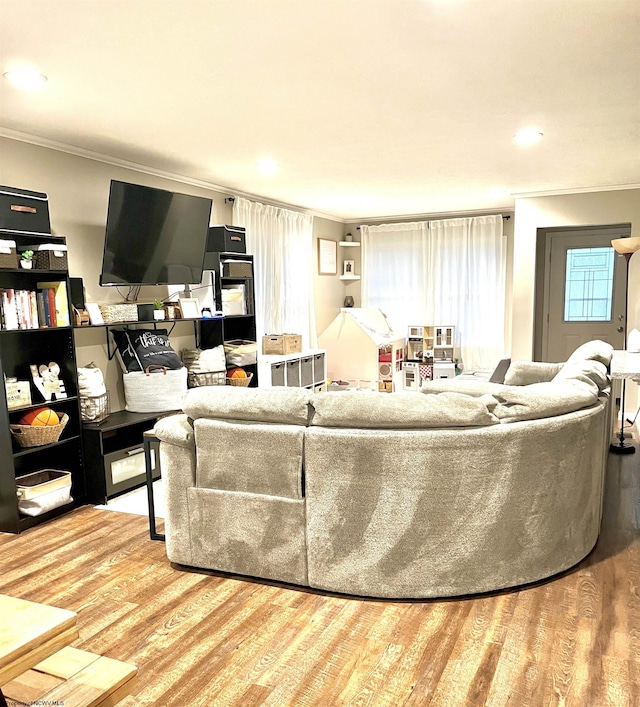 living room with ornamental molding and hardwood / wood-style floors