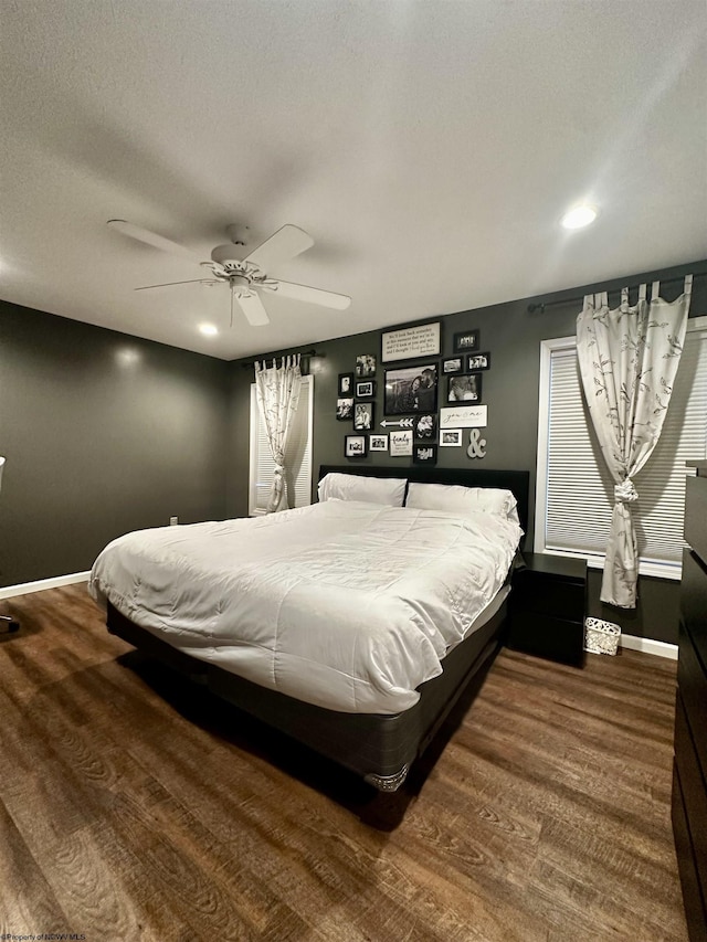 bedroom with hardwood / wood-style floors, a textured ceiling, and ceiling fan