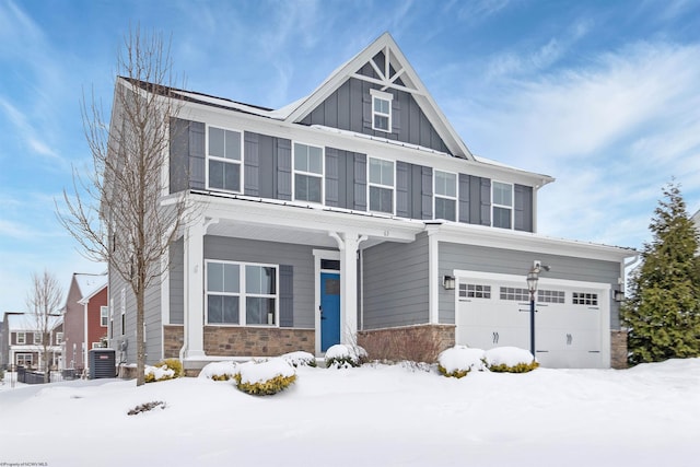 craftsman inspired home with a garage and central AC unit