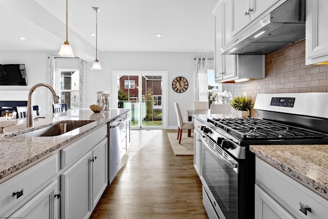 kitchen with white cabinetry, appliances with stainless steel finishes, sink, and pendant lighting