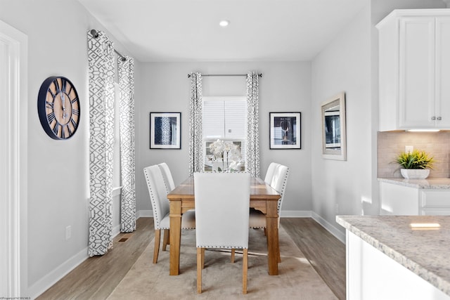 dining space with light hardwood / wood-style flooring