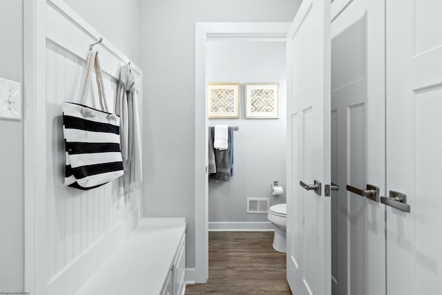 bathroom featuring wood-type flooring, vanity, and toilet