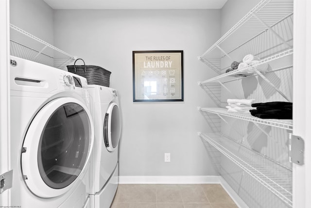 laundry room featuring light tile patterned floors and washer and dryer