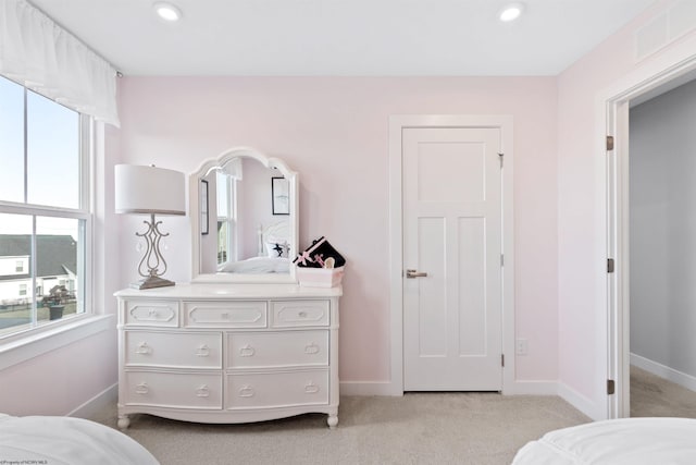 bedroom featuring light colored carpet