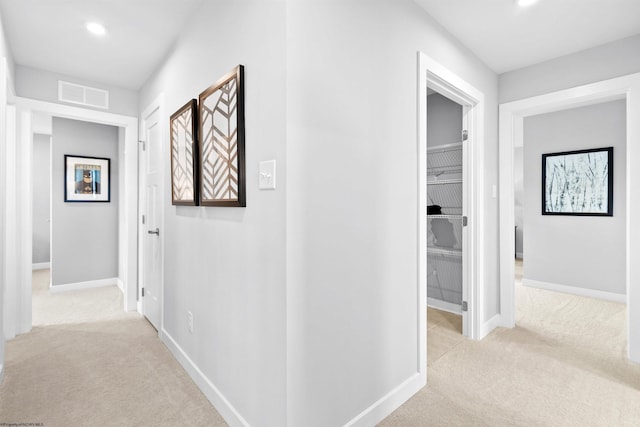 corridor with light colored carpet