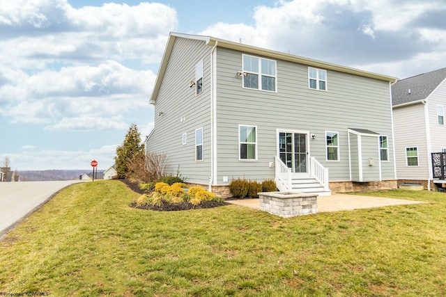 rear view of property with a patio and a lawn