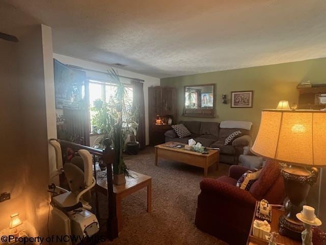 carpeted living room with a textured ceiling