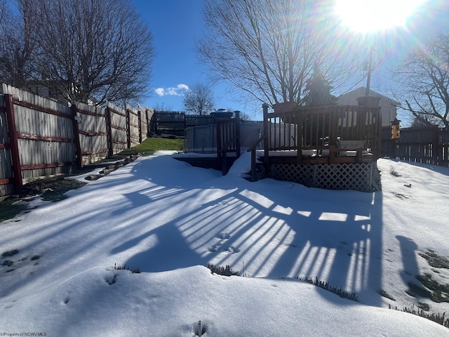 yard layered in snow with a playground