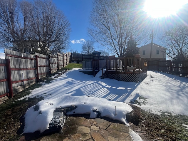 snowy yard featuring a deck