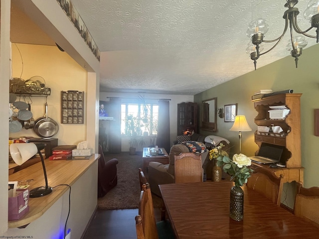 dining space featuring dark colored carpet and a textured ceiling