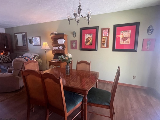 dining space featuring a chandelier, hardwood / wood-style floors, and a textured ceiling