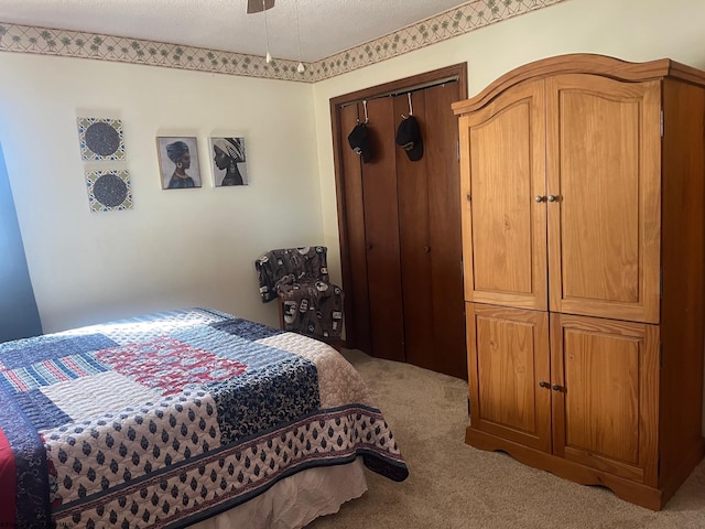 bedroom with light colored carpet and a textured ceiling