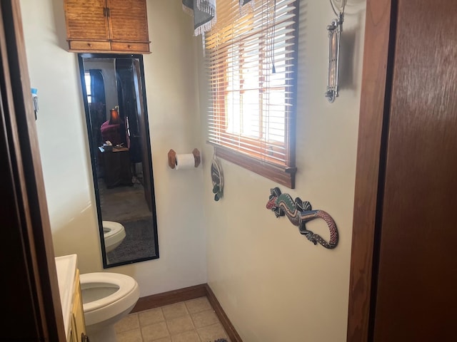 bathroom with tile patterned floors, vanity, and toilet