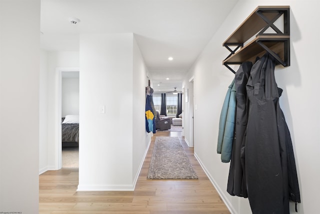 hallway with light hardwood / wood-style floors