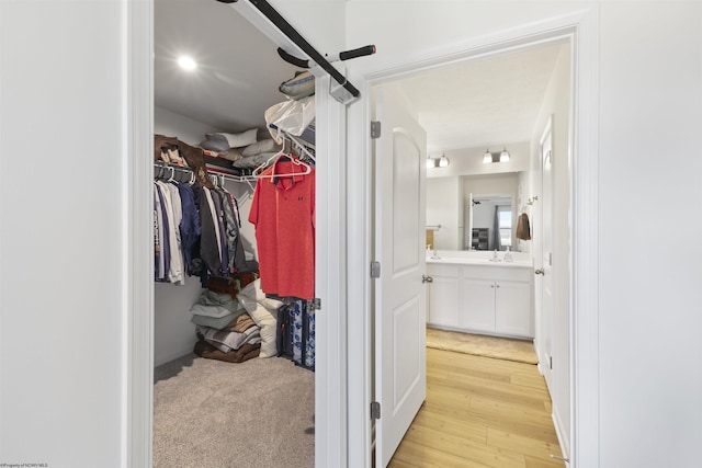 walk in closet featuring light hardwood / wood-style flooring