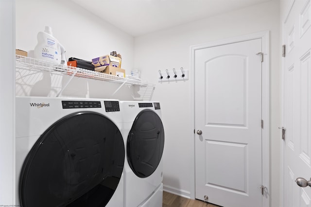 laundry room with hardwood / wood-style flooring and washer and dryer