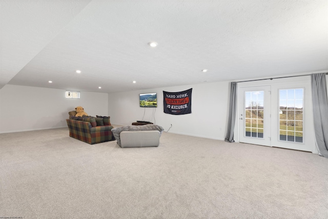 living room featuring light carpet and a textured ceiling