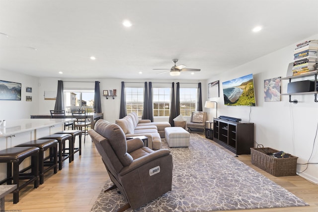 living room featuring ceiling fan and light hardwood / wood-style floors