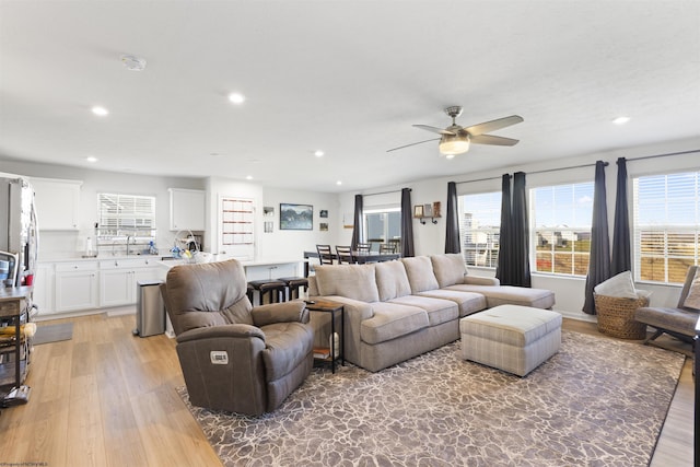 living room with hardwood / wood-style flooring and ceiling fan