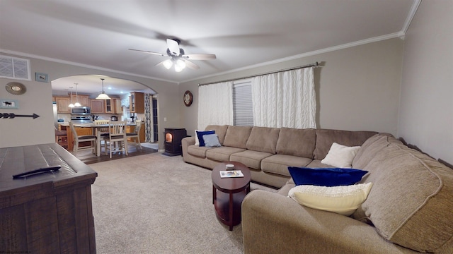 living room featuring crown molding, ceiling fan, and carpet