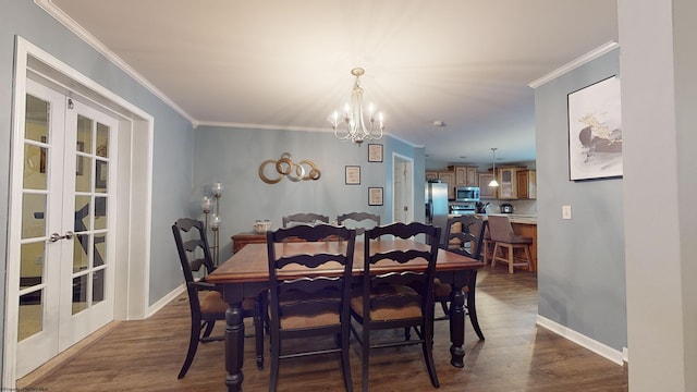 dining space with dark hardwood / wood-style flooring, ornamental molding, french doors, and an inviting chandelier