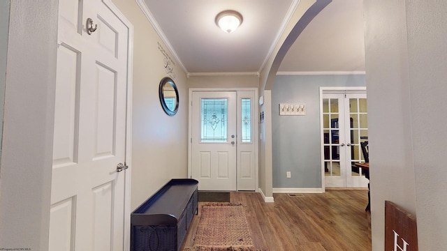 foyer featuring crown molding, hardwood / wood-style floors, and french doors