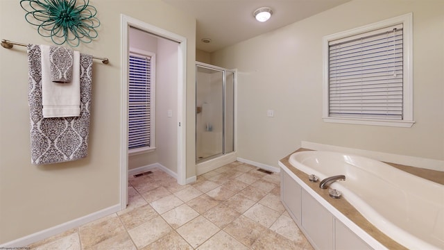 bathroom featuring separate shower and tub