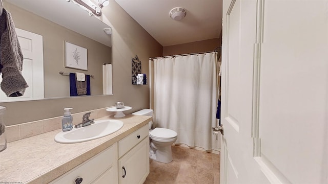 bathroom featuring vanity, curtained shower, and toilet