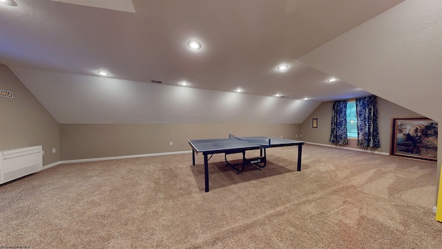 recreation room with vaulted ceiling and carpet