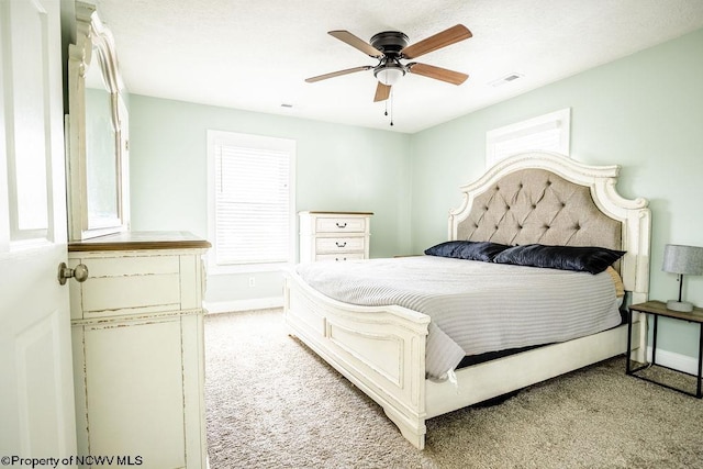 bedroom featuring light colored carpet and ceiling fan