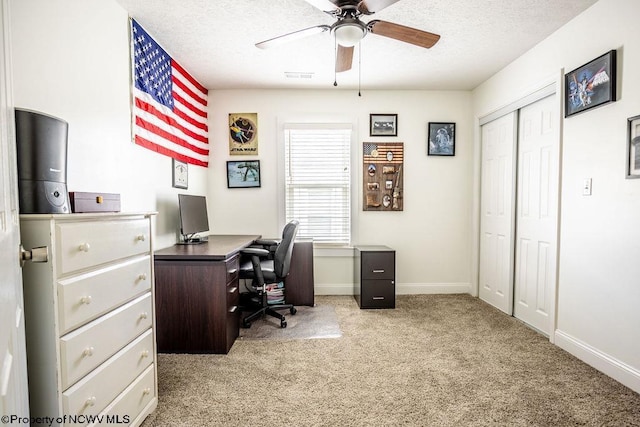 home office with light colored carpet, a textured ceiling, and ceiling fan