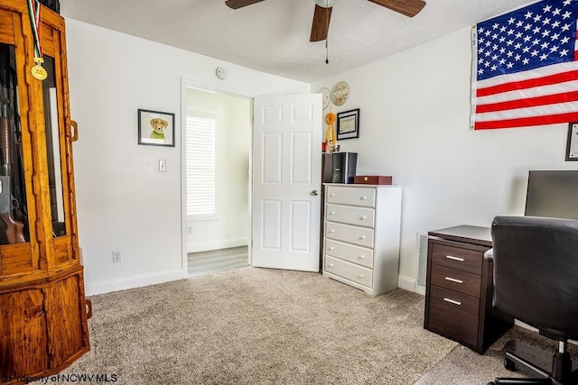 office area featuring light carpet and ceiling fan