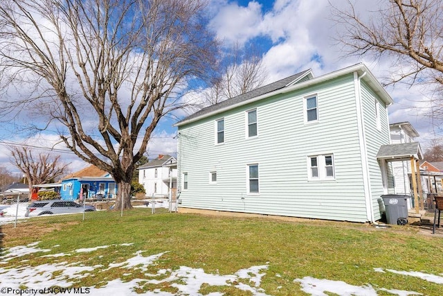 view of side of home featuring a yard