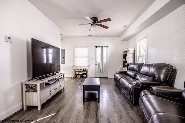 living room featuring dark hardwood / wood-style floors and ceiling fan