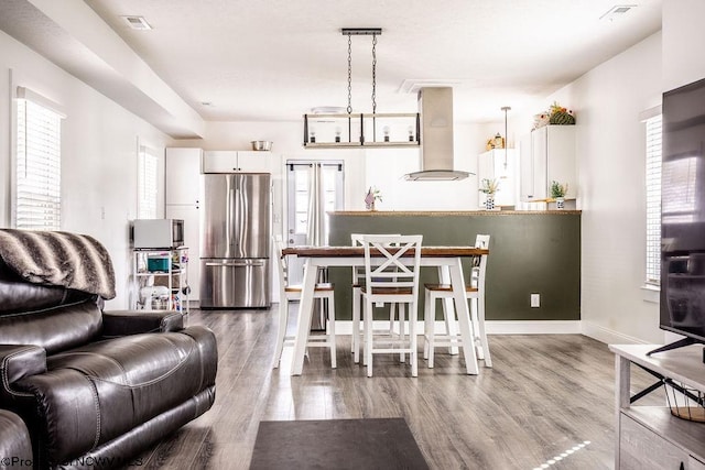 living room with plenty of natural light and wood-type flooring