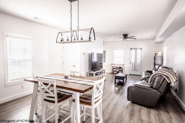 dining room featuring wood-type flooring and ceiling fan