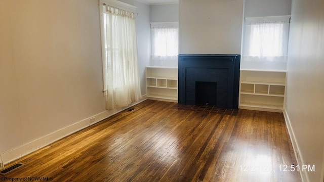 unfurnished living room with dark hardwood / wood-style floors