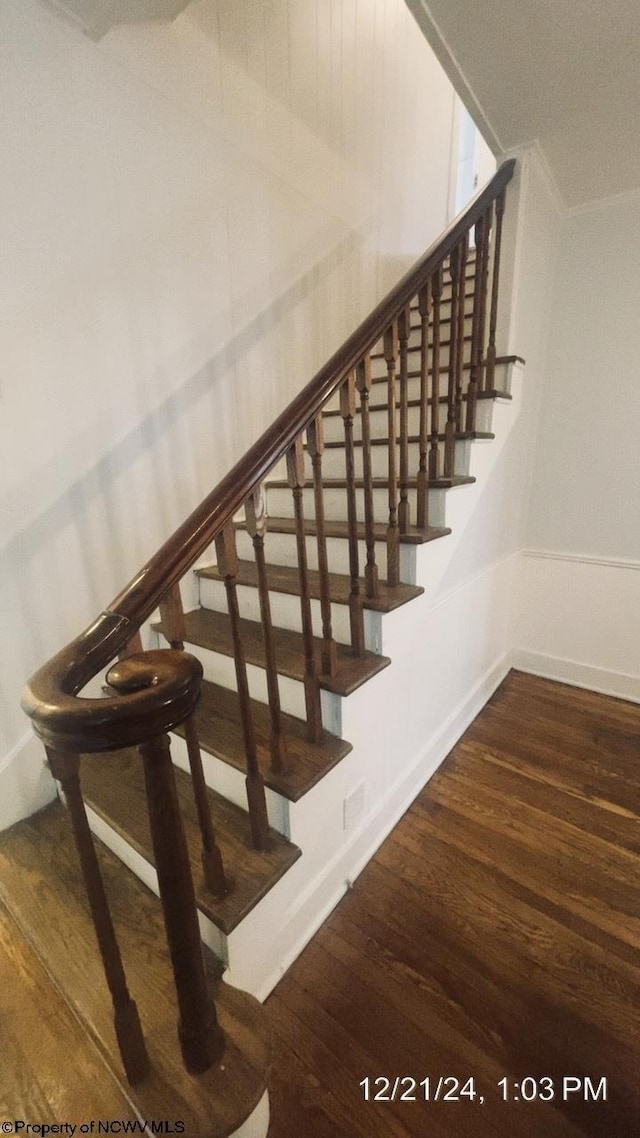 staircase with wood-type flooring