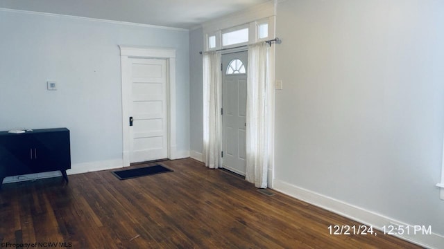 entryway featuring ornamental molding and dark hardwood / wood-style flooring