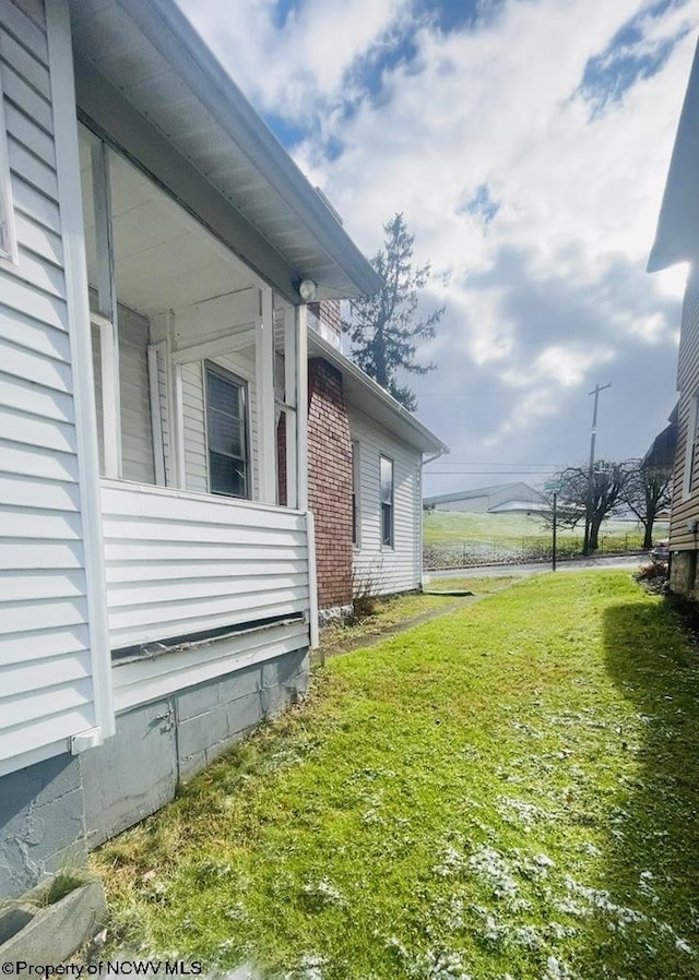 view of side of home featuring a lawn